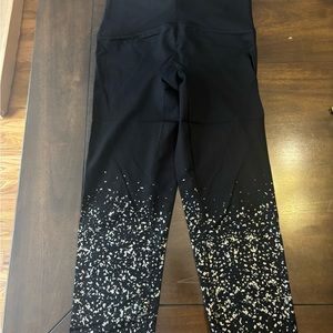 Spanx black workout legging with silver design at bottom of leg